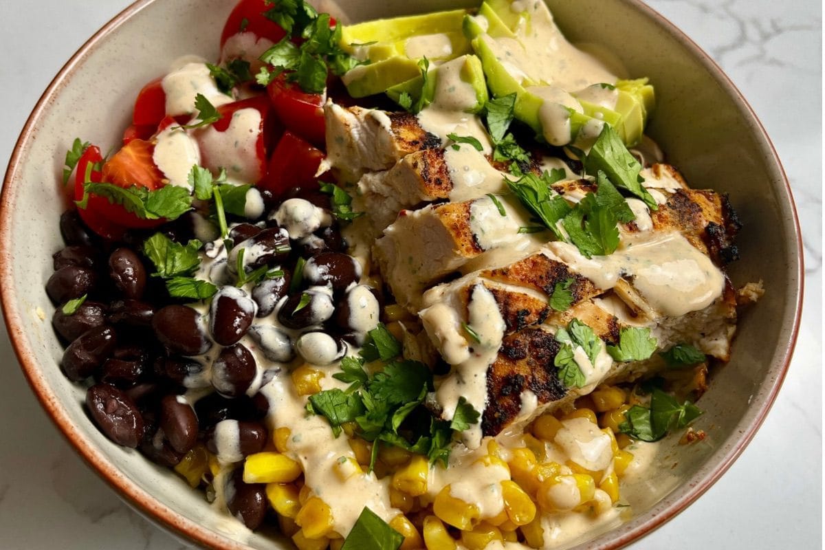 Plated southwest chicken bowl with chipotle lime cream sauce.