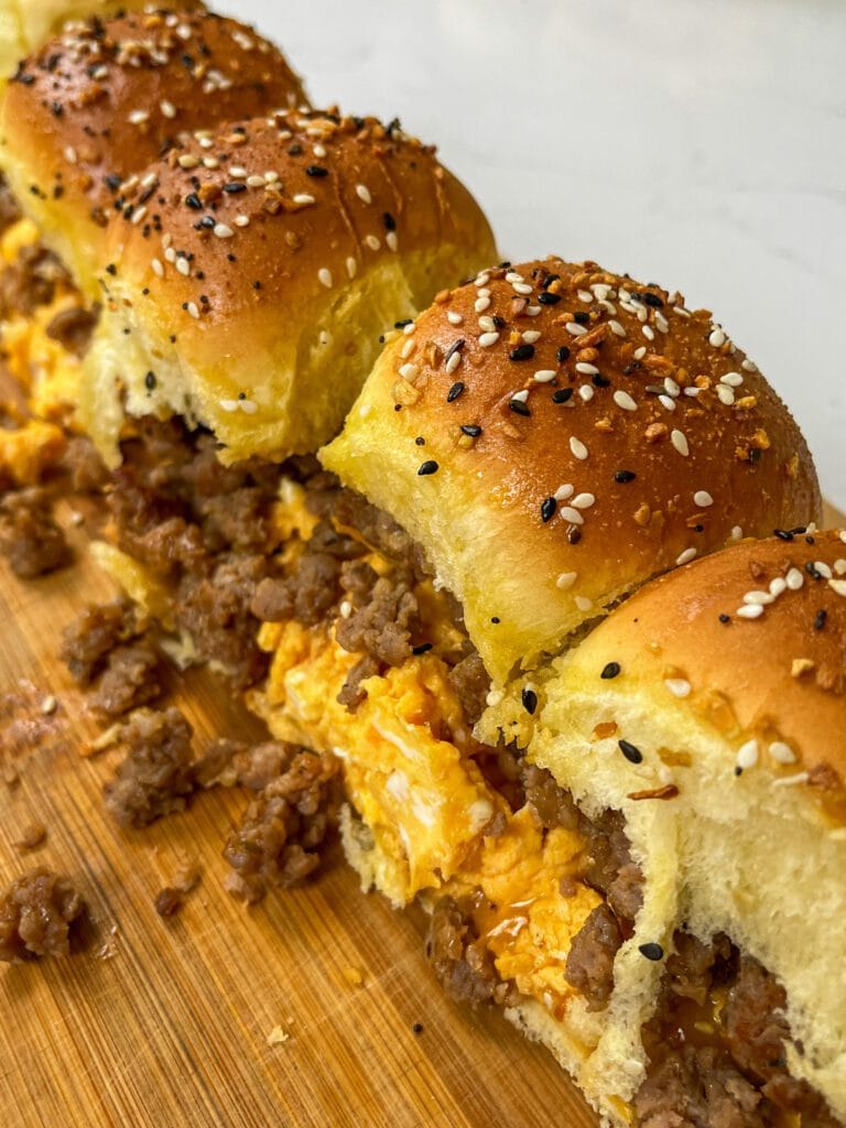 Hot Honey Breakfast Sliders in a row on a cutting board.