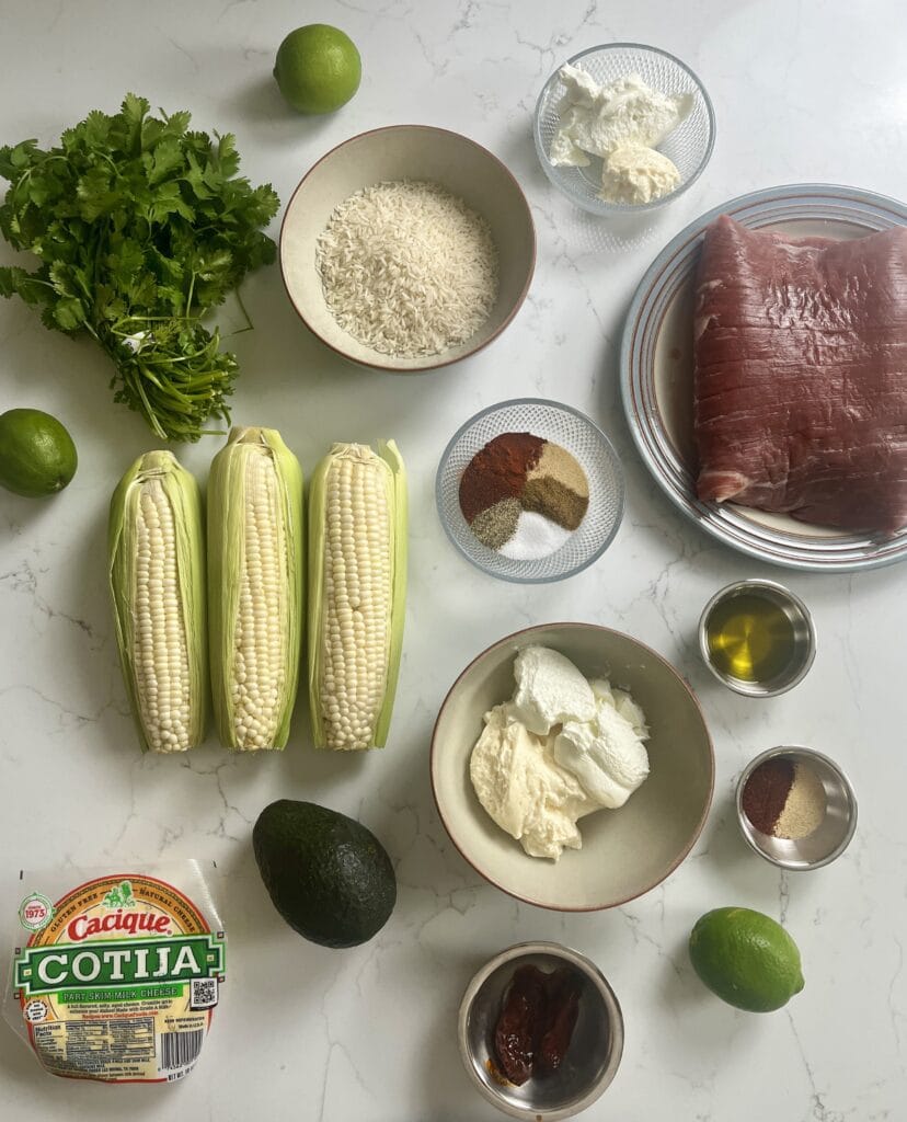 Ingredients for Street Corn Steak Bowls with Chipotle Lime Crema laid out on the counter.